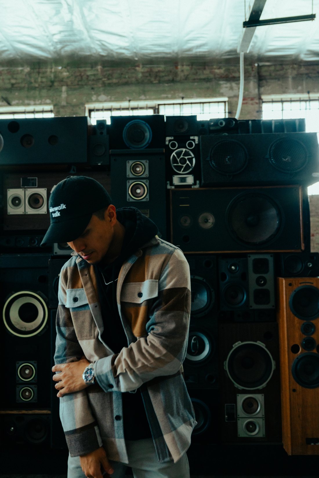 SAYMØRE in front of a stacked speaker wall